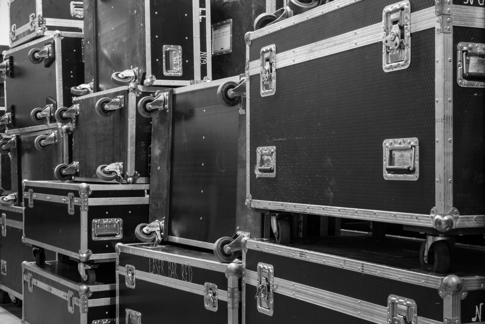 A stack of black ATA cases in a warehouse represent the question, “what is an ATA case?”