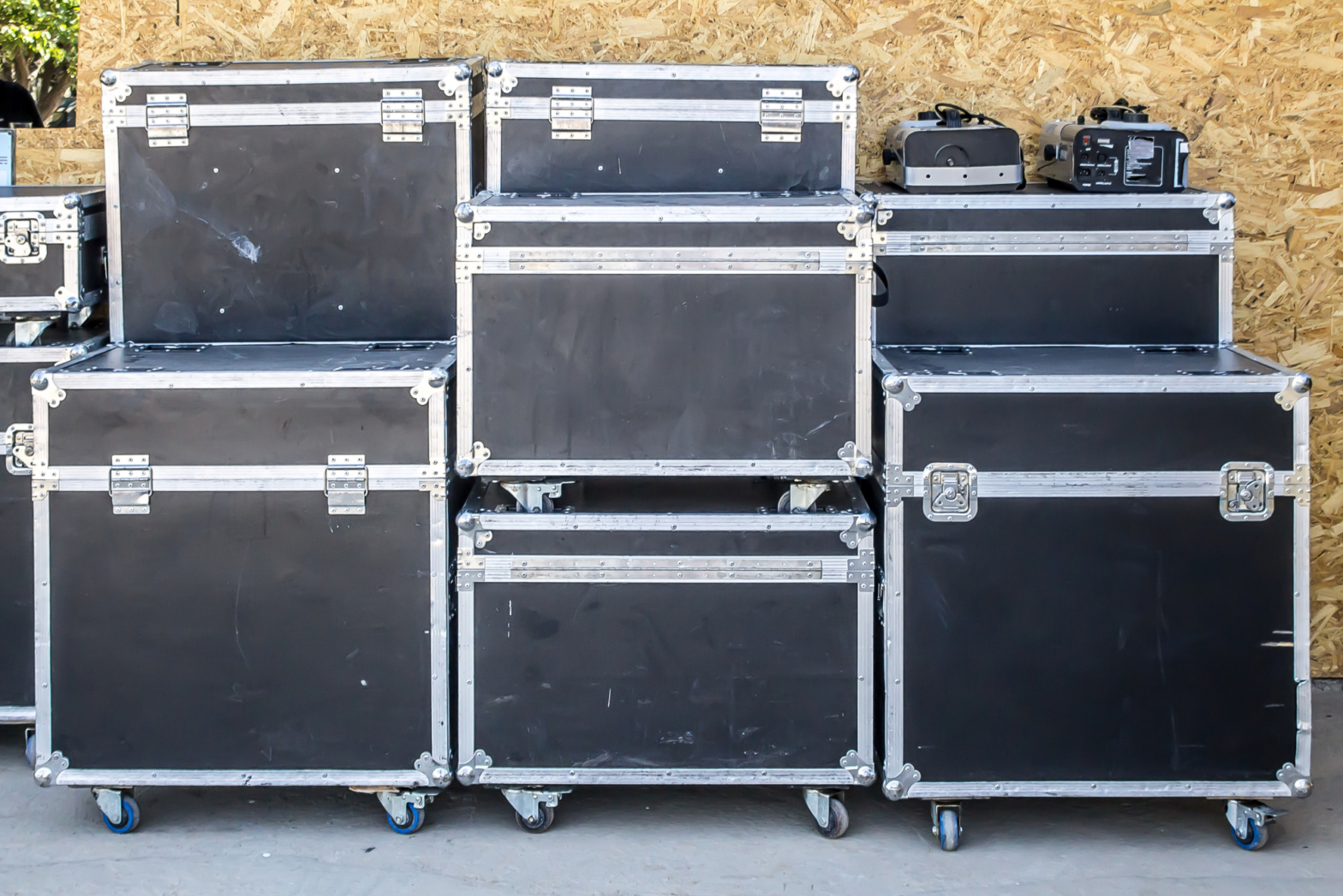 A group of truck cases stack on top of each other in preparation of being loaded into a trailer.